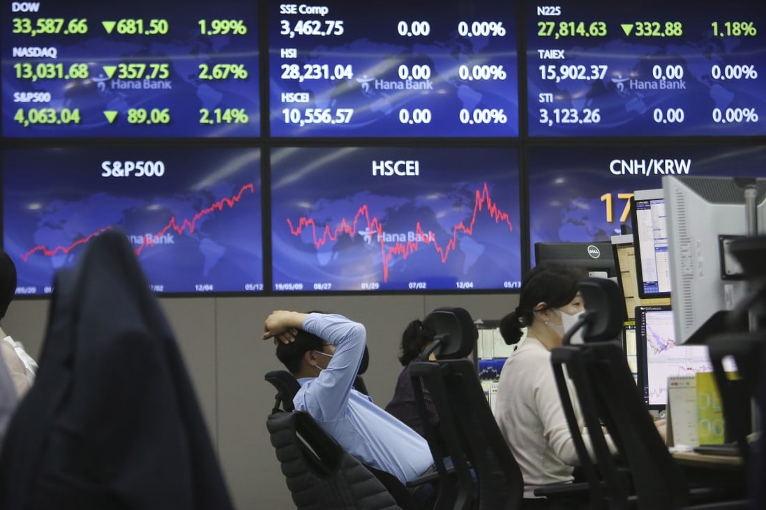 A currency trader watches the monitors at the foreign exchange dealing room of the KEB Hana Bank headquarters in Seoul, South Korea, on May 13. Asian stock markets followed Wall Street lower for a second day on Thursday after unexpectedly strong US consumer price rises fuelled worries inflation might drag on an economic recovery. Photo: AP