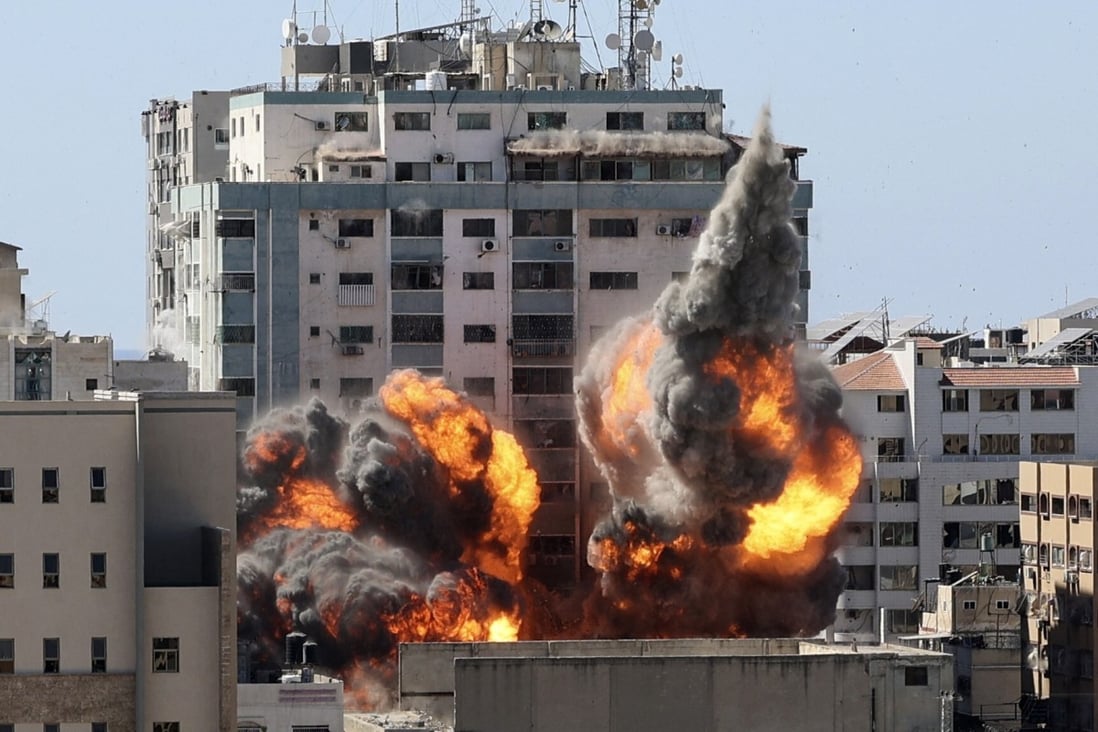 A ball of fire erupts from the al-Jala Tower as it is destroyed in an Israeli airstrike May 15, 2021. Photo: AFP