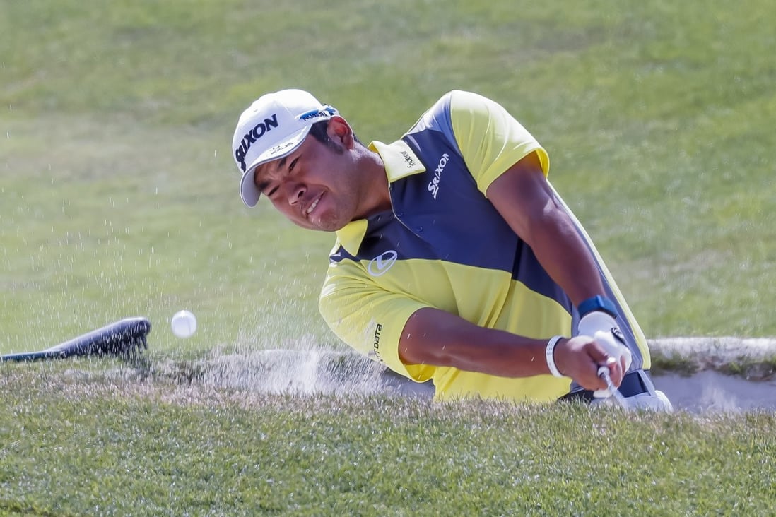 Hideki Matsuyama hits from a bunker at the seventeenth green during a practice round for the 2021 PGA Championship. Photo: Reuters