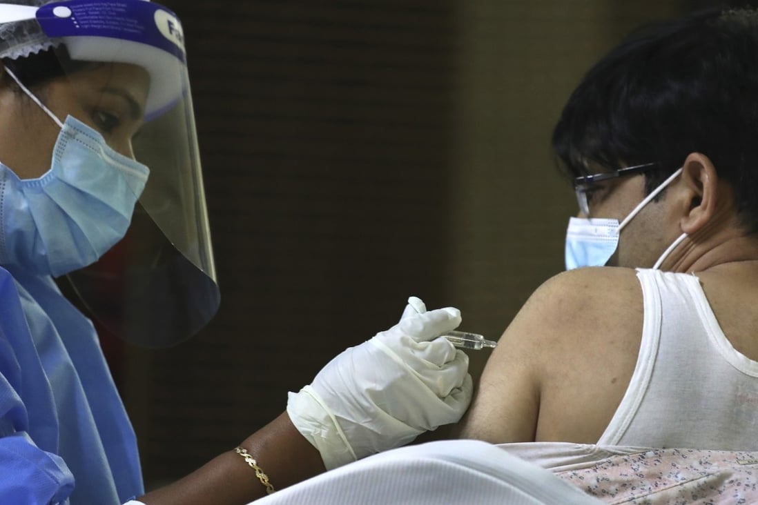 A man gets his Sinopharm Covid-19 shot at temple in Dubai in February. Photo: AP