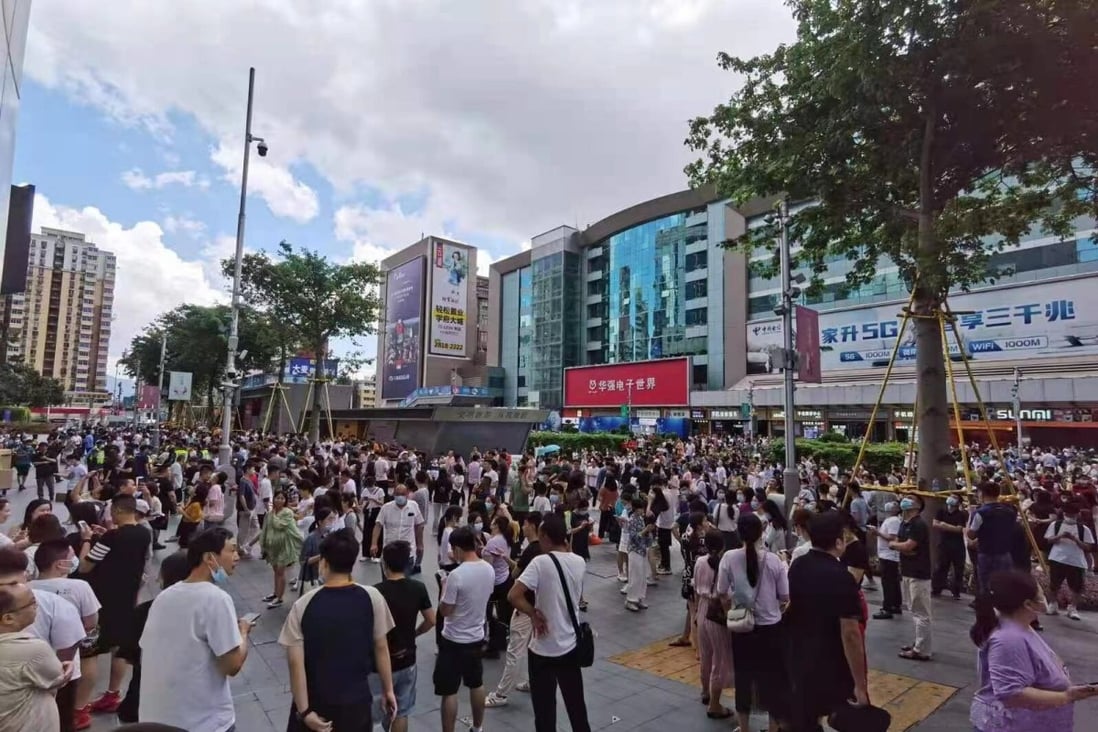 A photo posted on Chinese social media shows people in the street after they ran out of the SEG Plaza on Tuesday. The city’s government has said the structure is safe. Photo: Handout