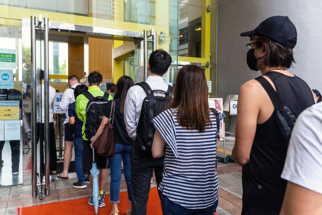 People queue up outside a community vaccination centre administering the BioNTech Covid-19 vaccine in Hong Kong on April 26. With only 16 per cent of the population vaccinated, Hong Kong has a long way to go to reach the 70 per cent required for herd immunity. Photo: Bloomberg