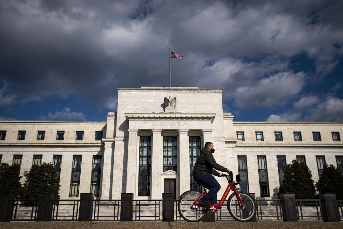 A man rides past the Federal Reserve building in Washington, on January 22. Photo: Bloomberg