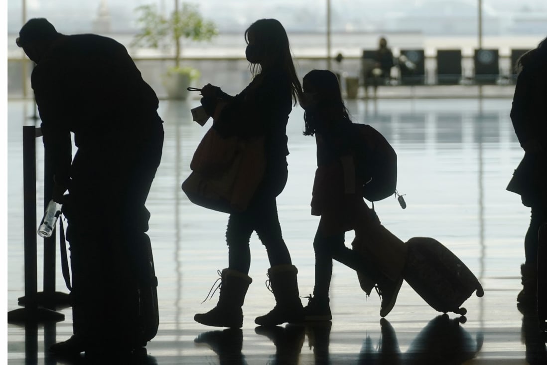 Masked travellers walk through Salt Lake City International Airport on March 17. Governments around the world have yet to agree terms for resuming international travel. Photo: AP