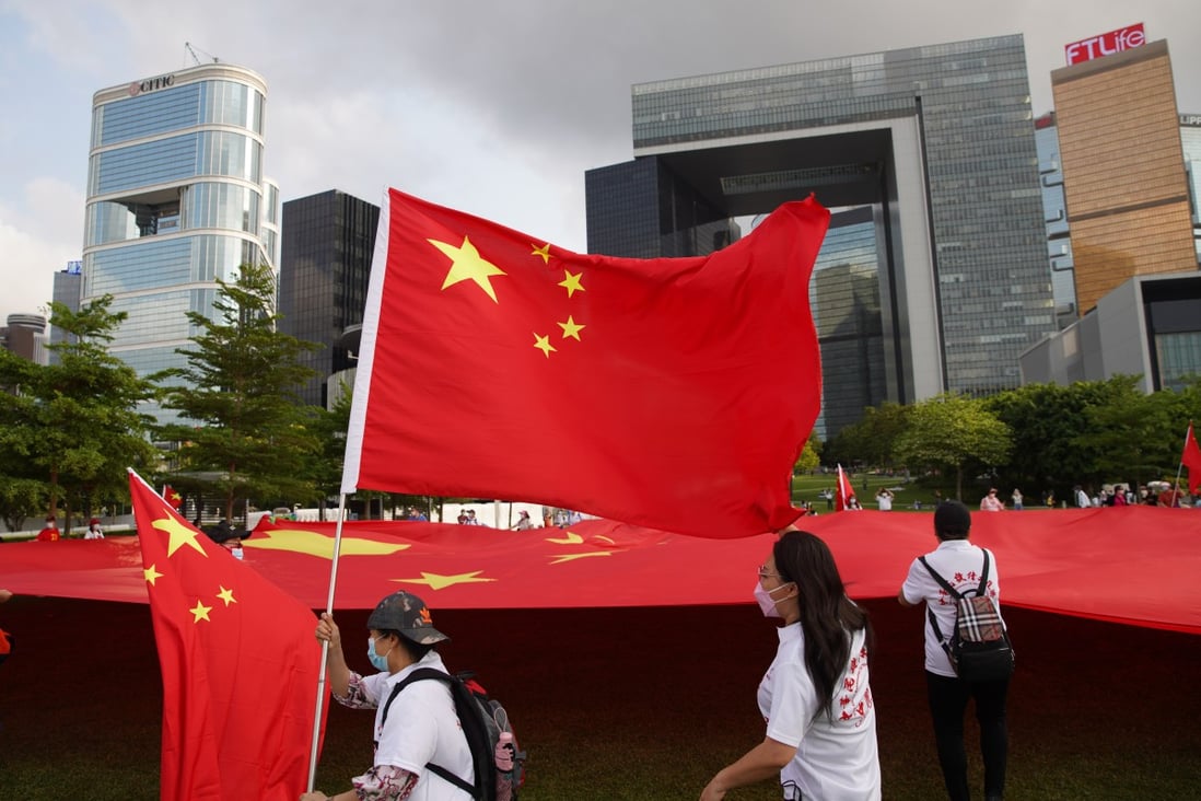 A group of people display the Chinese national flag outside Hong Kong government offices. Photo: Winson Wong