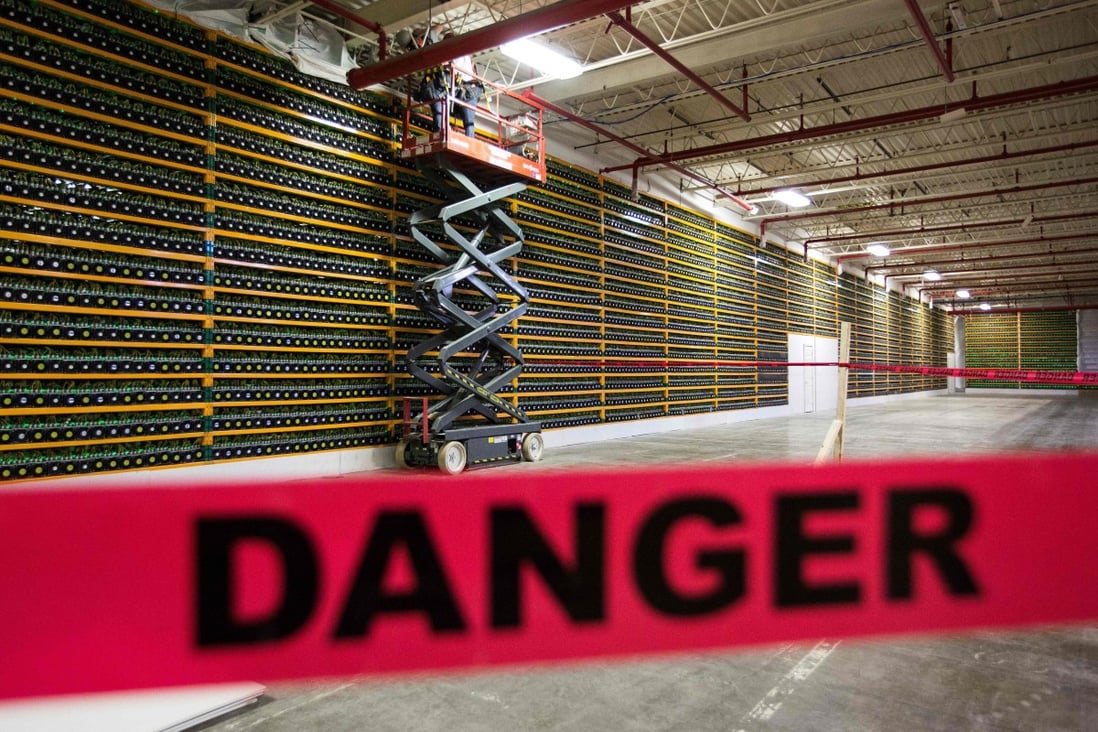 Two construction workers use a lift along a wall of bitcoin mining at Bitfarms in Saint Hyacinthe, Quebec, Canada in March 2018. Change is coming to cryptocurrency markets whether the proponents of these digital currencies like it or not. Photo: AFP