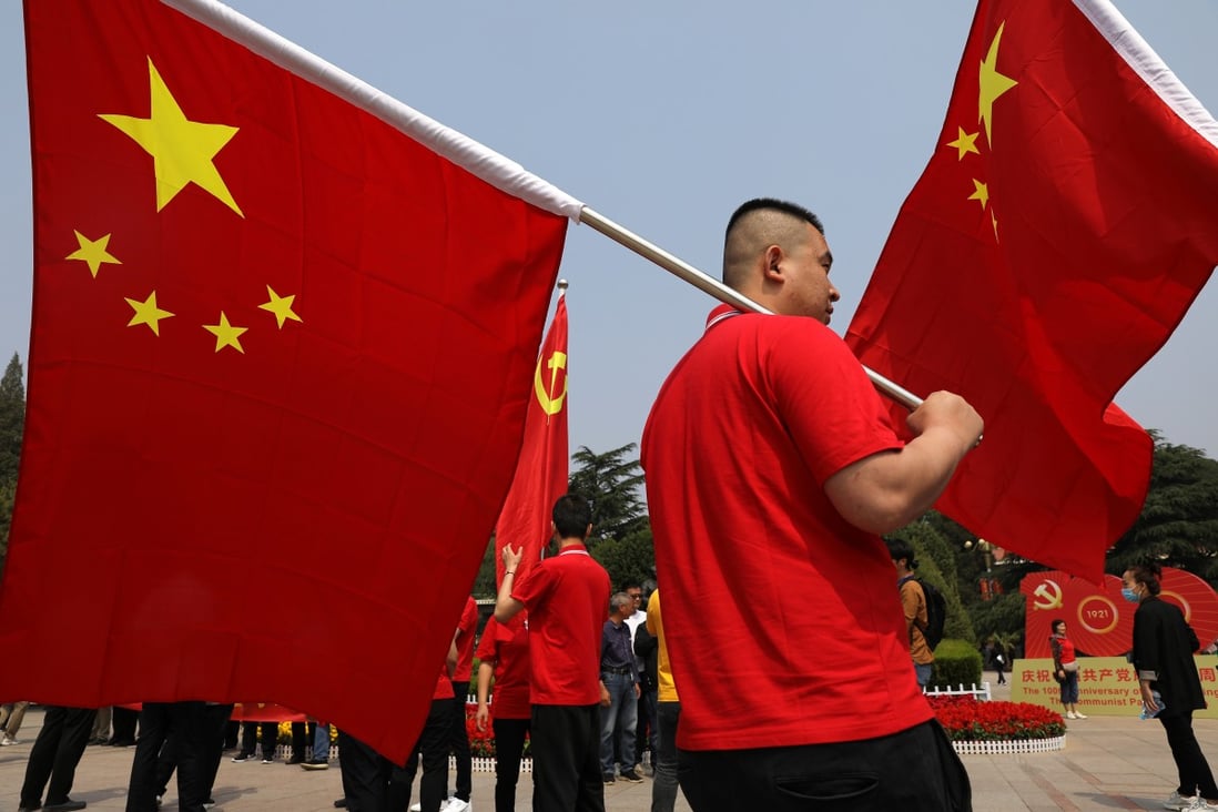 A visitor carries a Chinese flag at the Xibaipo Memorial Hall during a government-organised tour earlier this month. Photo: Reuters