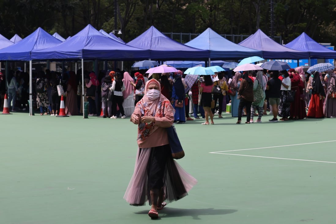 Foreign domestic helpers in Hong Kong queue up in Victoria Park for a second Covid-19 screening ordered by the government, an order denounced by many commentators as discriminatory. Photo: Nora Tam