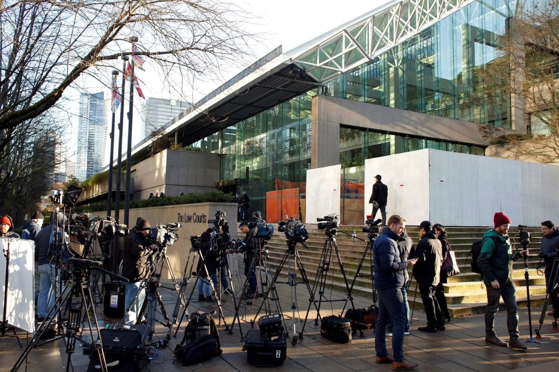 Journalists wait outside the BC Supreme Court complex in 2018. Photo: Reuters