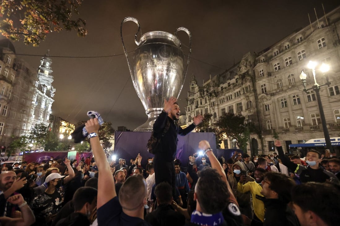 Chelsea fans celebrate in front of a giant replica of the Champions League trophy in Porto. Photo: AP