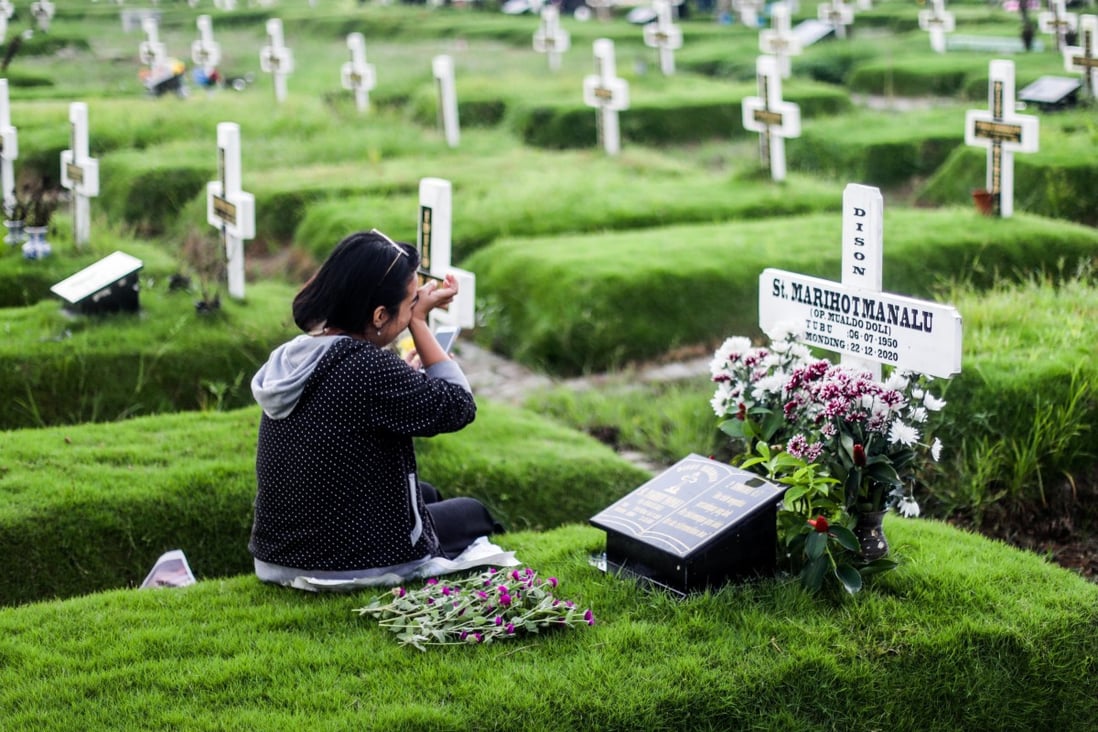 A relative mourns at the Medan Covid-19 cemetery. Photo: EPA-EFE