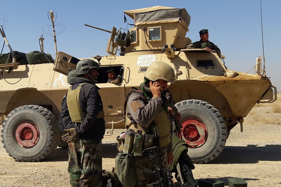 On May 5, Afghan security forces stand near an armoured vehicle during fighting between Afghan security forces and Taliban fighters on the outskirts of Lashkar Gah, the capital city of Helmand province. Photo: AFP