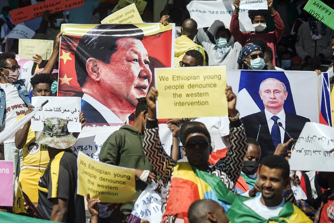 Protesters hold the portraits of Chinese President Xi Jinping and Russian President Vladimir Putin at a rally in Addis Ababa on May 30 against US sanctions over the conflict in Tigray. Photo: AFP