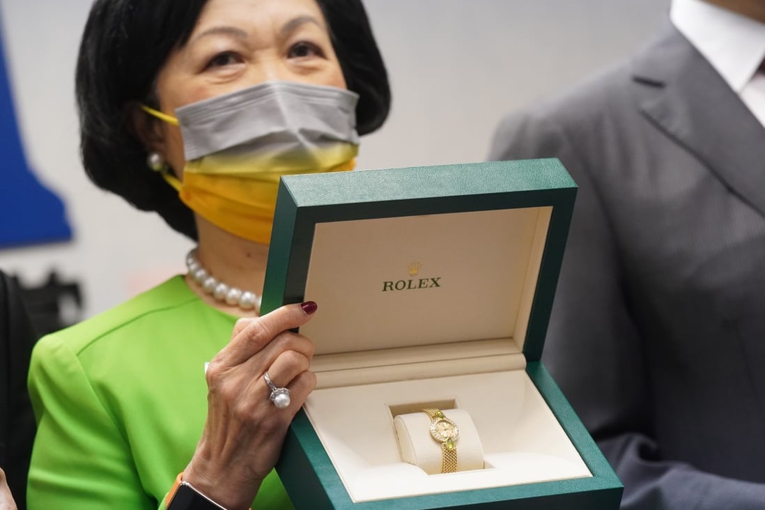 New People's Party chairwoman Regina Ip poses with a Rolex to be offered up in a lottery for vaccinated party allies. Photo: Sam Tsang
