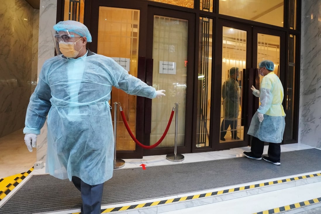 Some workers seen outside a designated quarantine hotel in North Point, Hong Kong, in December 2020. Photo: Felix Wong
