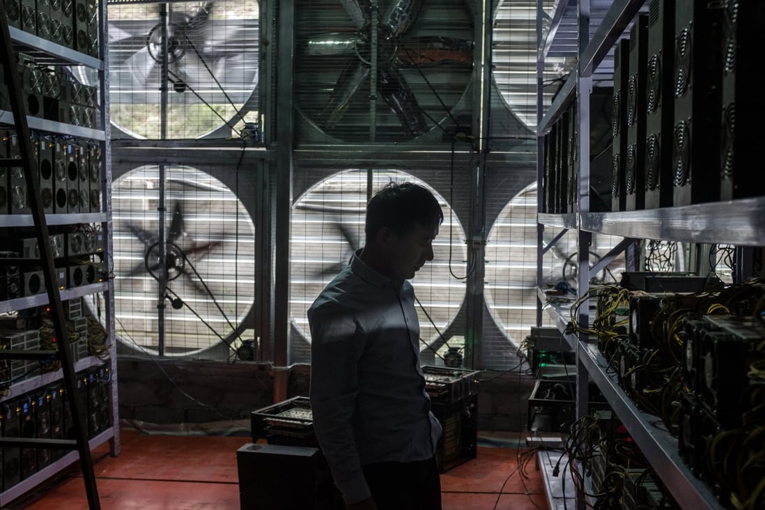 A bitcoin mine owner stands in front of a wall of cooling fans at his mine, where he houses and operates machines for miners who do not want to move to rural Sichuan, in Ngawa Tibetan and Qiang Autonomous Prefecture, on September 27, 2016. Photo: EPA