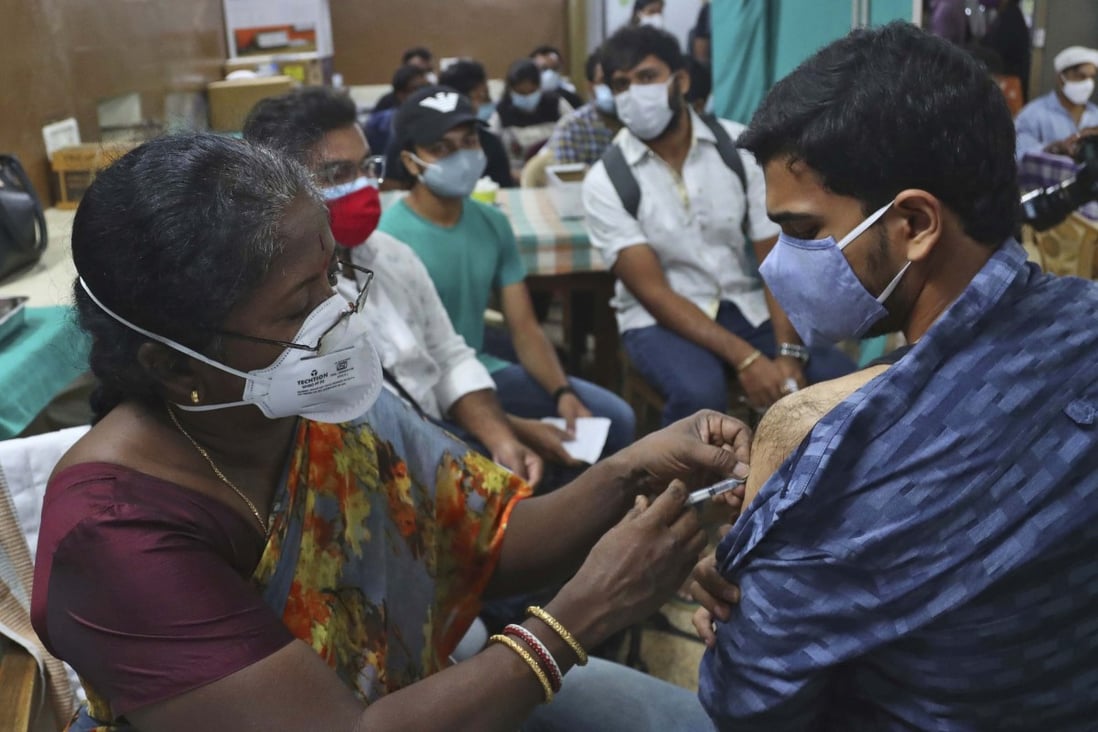 An Indian health worker administers the Covishield vaccine to a student preparing to travel overseas. Photo: AP