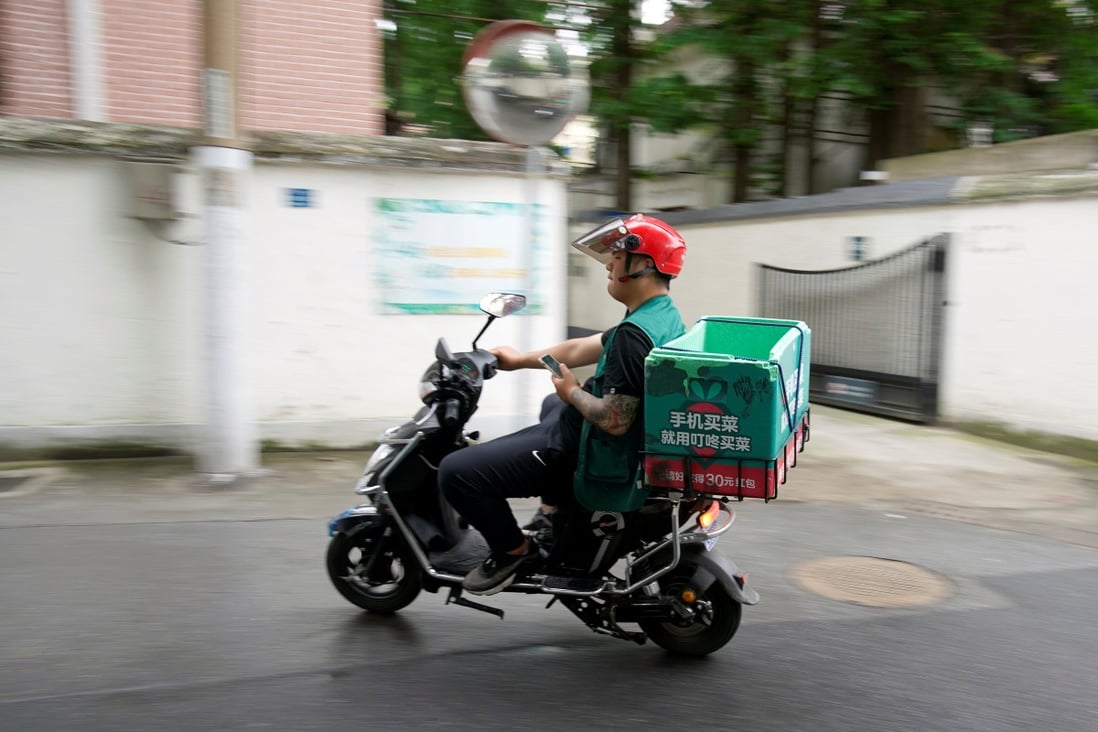 A delivery worker of Chinese online grocery Dingdong Maicai is seen in Shanghai. The company is preparing to list on the New York Stock Exchange. Photo: Reuters