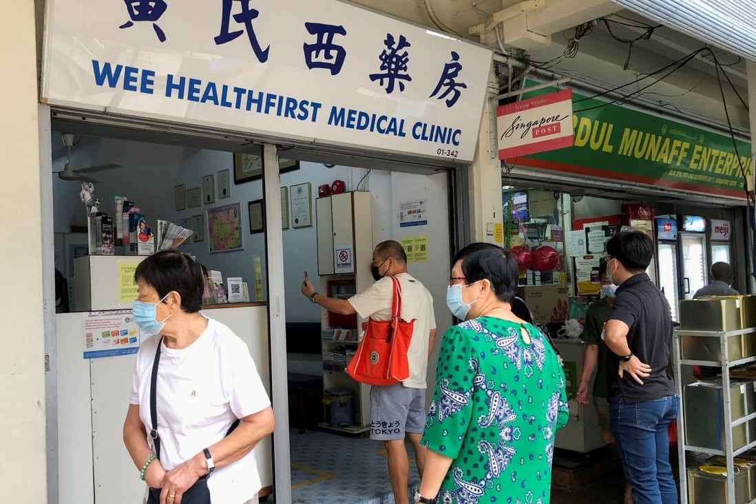 People are seen outside a clinic in Singapore that offers the Chinese-made Sinovac coronavirus jab. Photo: Reuters