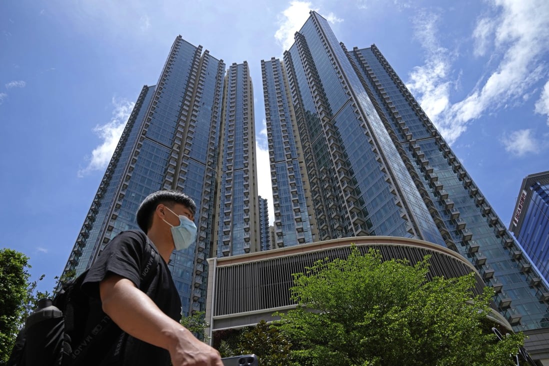A man walks in front of the Grand Central residential building complex where one of the HK$10.8 million flats will be offered as a prize in a lucky draw for a vaccine incentive. Photo: AP