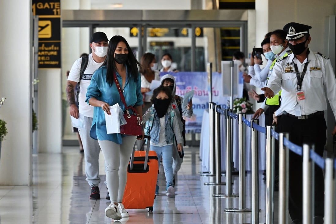 Passengers from Abu Dhabi arrive at Phuket airport on Thursday. Photo: AFP