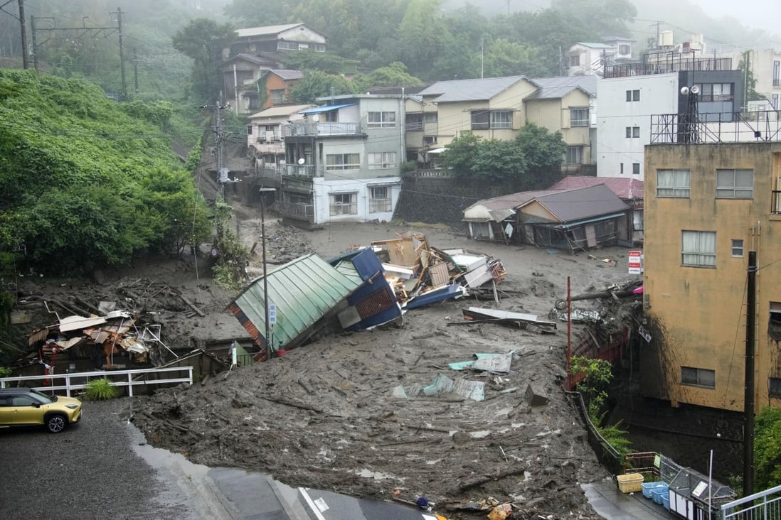 Houses are damaged by mudslide following heavy rain in Atami, southwest of Tokyo. Photo: Kyodo via AP