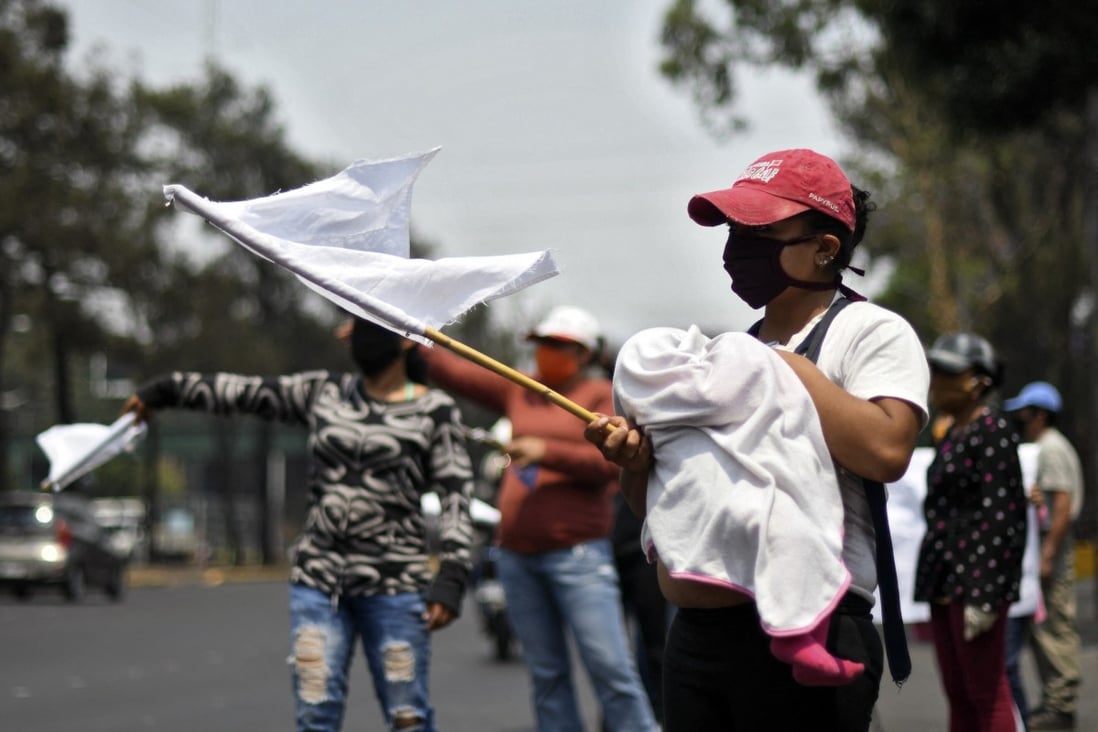 People wave white flags as a signal they need food in Guatemala last year. A similar white flag campaign sprang up in Malaysia over the past week. Photo: AFP