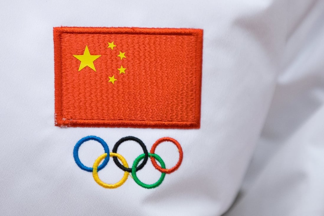 A Chinese flag and Olympic sign are seen on a jacket worn by a Chinese sportsman during a ceremony to launch the flag tour of the Beijing 2022 at Badaling Great Wall in February, 2018. Photo: EPA
