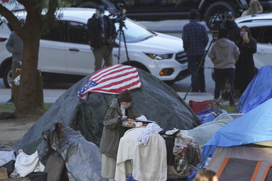 A homeless woman at Echo Park Lake in Los Angeles. Photo: AP