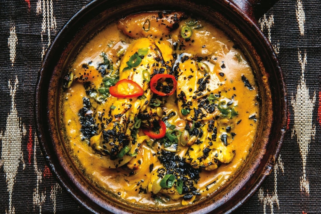 Yellow chicken adobo, a dish from the Philippines, with turmeric and charred coconut. Photo: Conde Nast via Getty Images