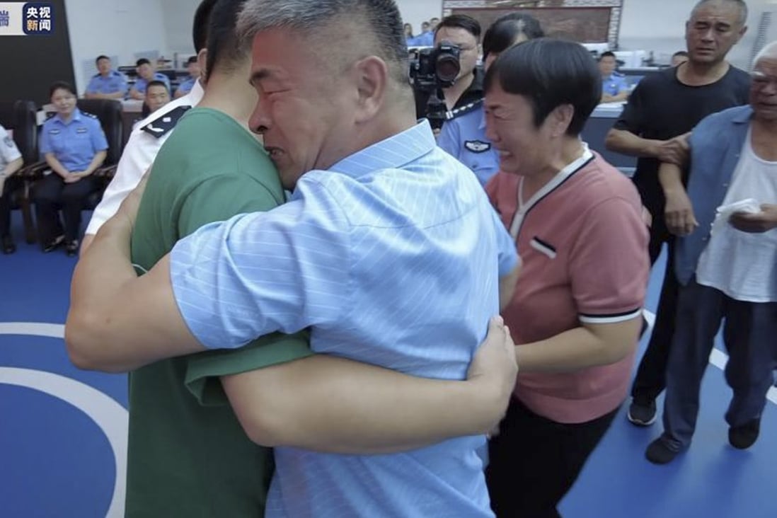 The moment a father and mother are reunited with their missing son 24 years after he was abducted. Photo: CCTV