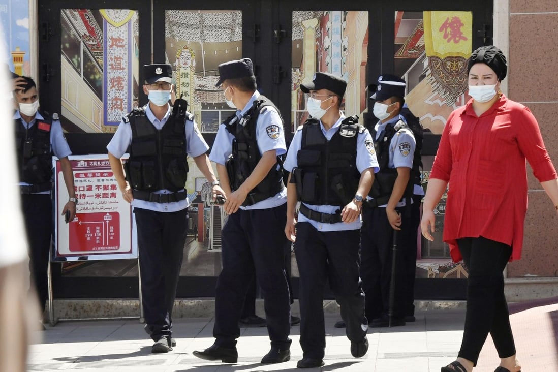 Police officers patrol near the International Grand Bazaar in Urumqi in China’s Xinjiang Uygur autonomous region on July 5. Photo: Kyodo