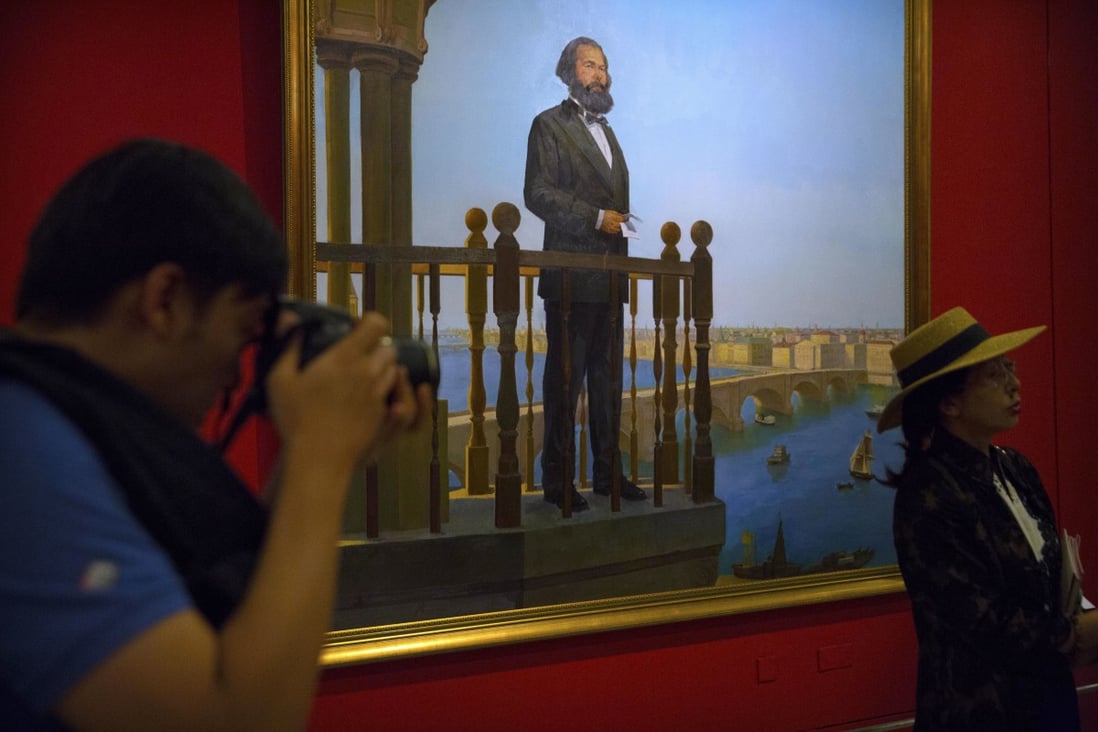 Visitors look at paintings at an exhibition to commemorate the 200th anniversary of the birth of Karl Marx at the National Museum in Beijing on May 5, 2018. An opinion piece published by the CPPCC Daily refers to Marx’s ideals, so that China’s Big Tech companies’ can end their gruelling 996 work culture. Photo: AP