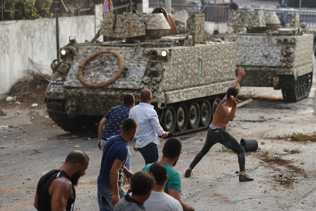 Supporters of Saad Hariri clash with Lebanese soldiers in Beirut. Photo: AP