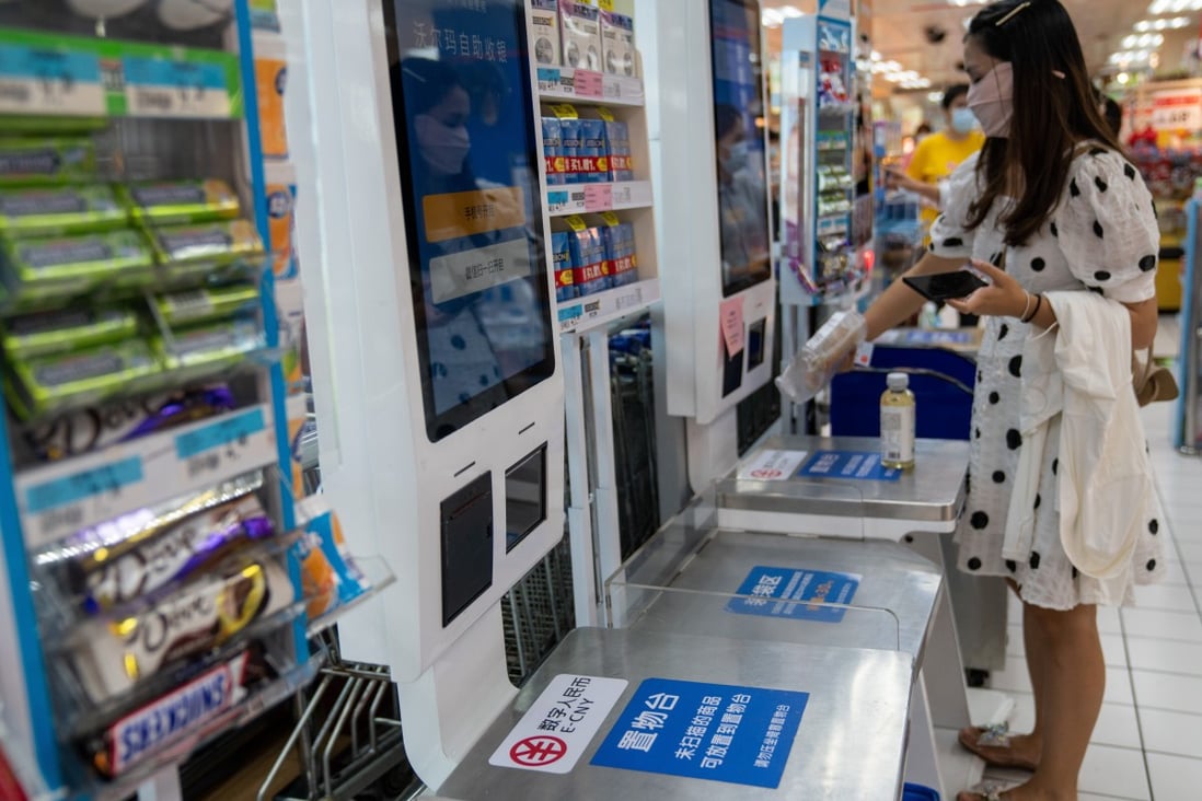 Signs indicate where China’s e-yuan can be used at a supermarket in Shenzhen, China. Photo: Bloomberg