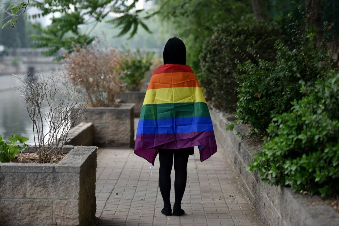 A gay student wears a rainbow flag in Beijing. A crackdown in mainland China on social media accounts operated by pro-lesbian, gay, bisexual and transgender student groups could be perceived as having political overtones. Photo: AFP