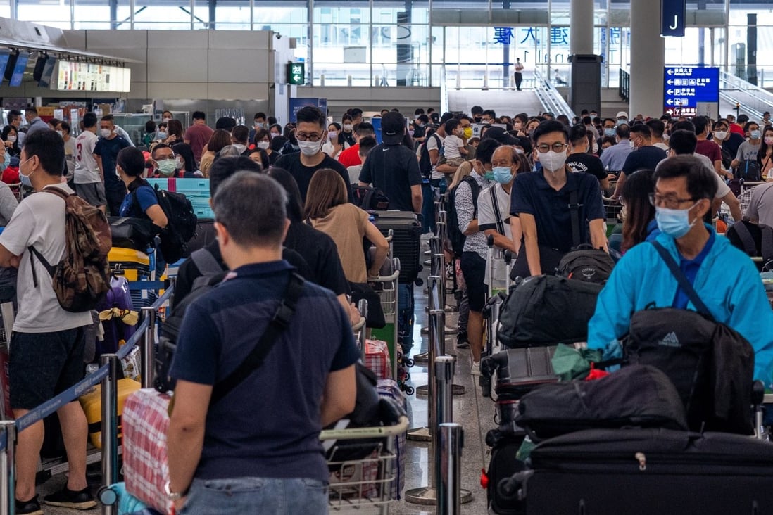 People pack the check-in area for their flight to Britain at Hong Kong’s International Airport on July 18, 2021. Photo: AFP