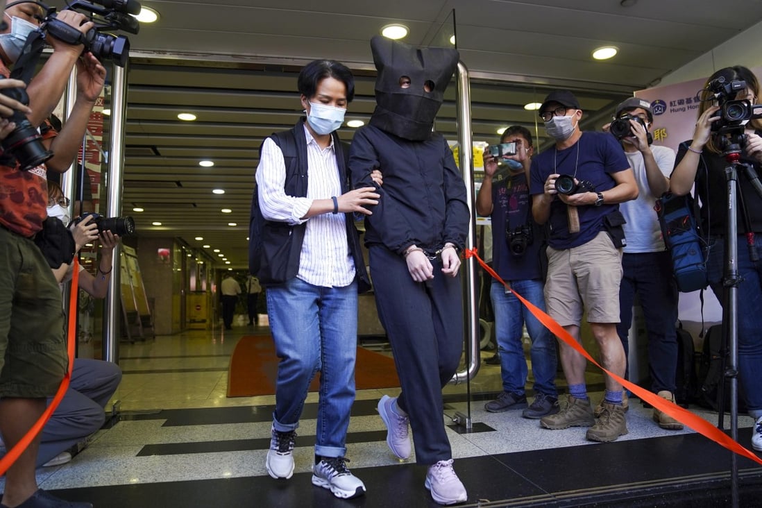 One of the five suspects arrested under the national security law on Thursday is walked out of Hung Hom Commercial Centre by police. Photo: Sam Tsang
