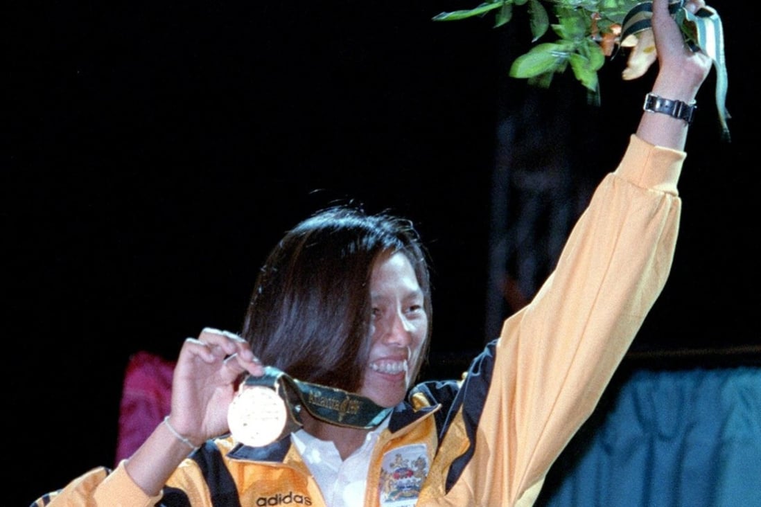Hong Kong windsurfer Lee Lai-shan shows off her Olympic gold medal at the presentation ceremony in Savannah, Georgia, in July 1996. Photo: David Wong