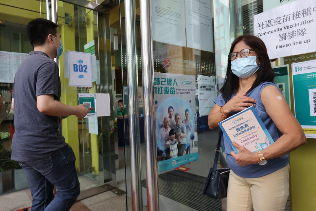 Hong Kong resident Evangeline Solis Santos has her photo taken by friends after being vaccinated with BioNTech earlier this month in Sai Ying Pun. Photo: May Tse