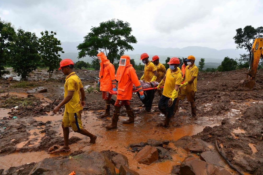 Target Disaster Response Force (TDRF) workers carry the body of a victim at the site of a landslide at Taliye, India on Saturday. Photo: AFP