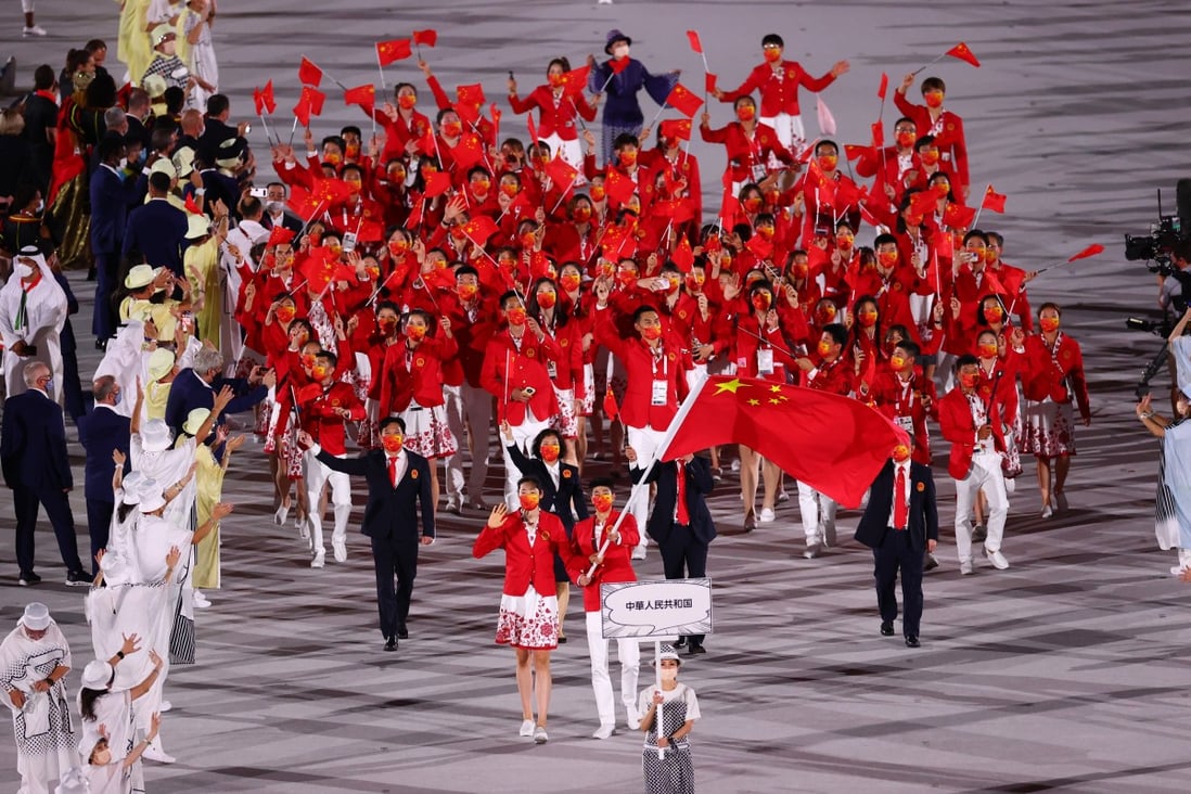 Flag bearers Zhao Shuai and Ting Zhu lead the China contingent during the athletes’ parade at the opening ceremony of the Tokyo Olympics on Friday. Photo: Reuters