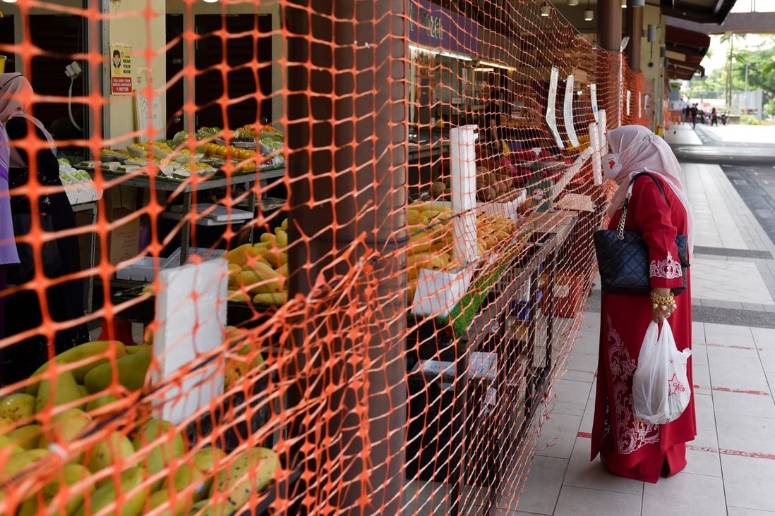 A wet market in Singapore is cordoned off to limit entry and exit points. Photo: Reuters