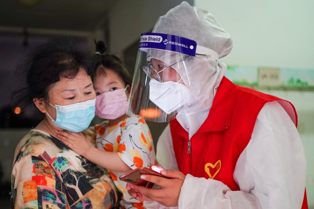 A volunteer helps residents at a Covid-19 testing site in Jiangning district of Nanjing, on Thursday. Photo: Xinhua