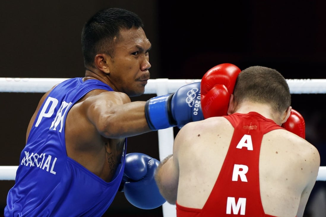 Eumir Marcial of the Philippines lands a punch on Arman Darchinyan of Armenia during their quarter-final contest at the Tokyo Olympics on Sunday. Photo: EPA-EFE