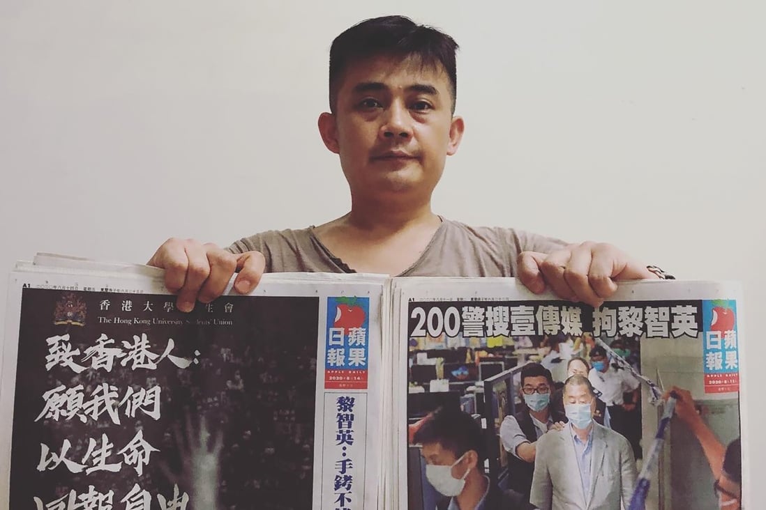 Ou Biaofeng, 40, pictured with a copy of the now defunct Hong Kong newspaper Apple Daily. Photo: Handout