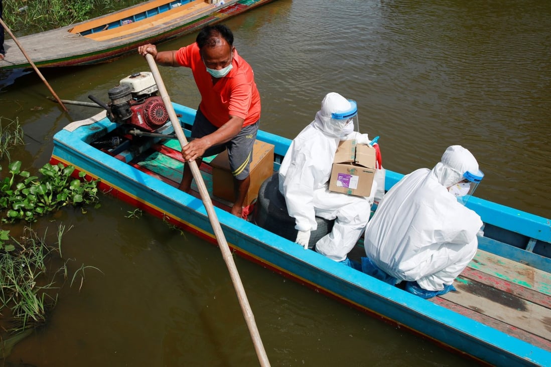 Health workers travel by boat to bring Covid-19 swab tests to rural residents near Bangkok. Photo: Reuters