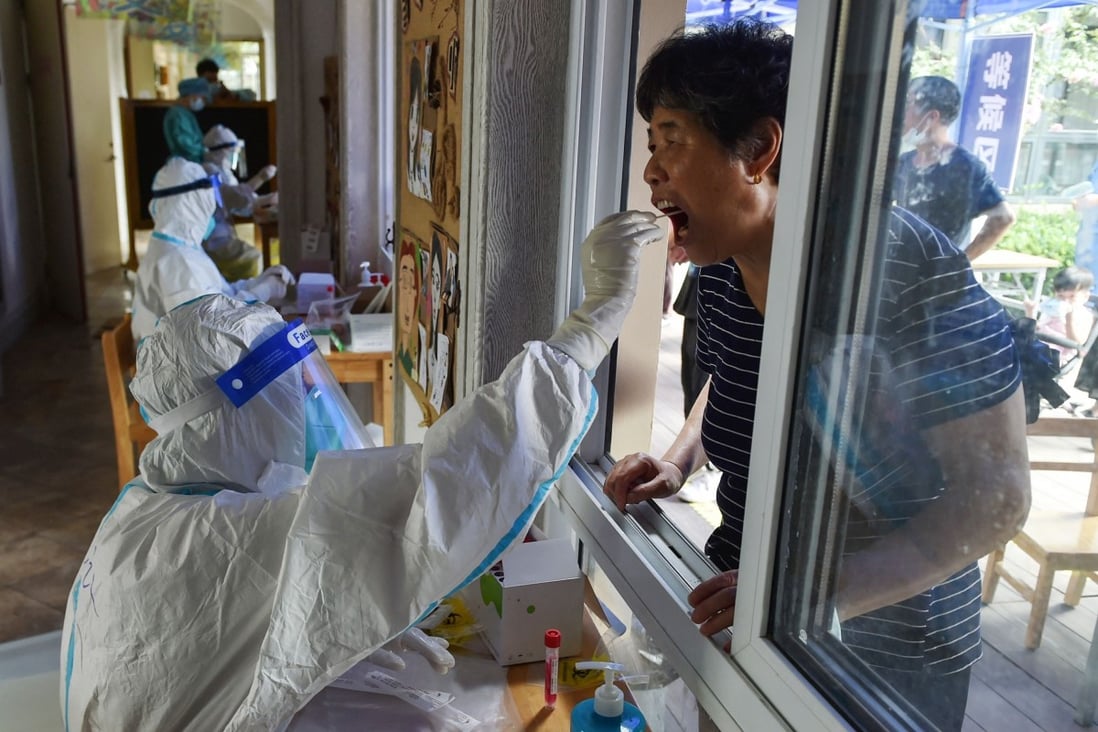 A resident gets tested in Nanjing on Monday as the country grapples with its most widespread outbreak in months. Photo: AFP