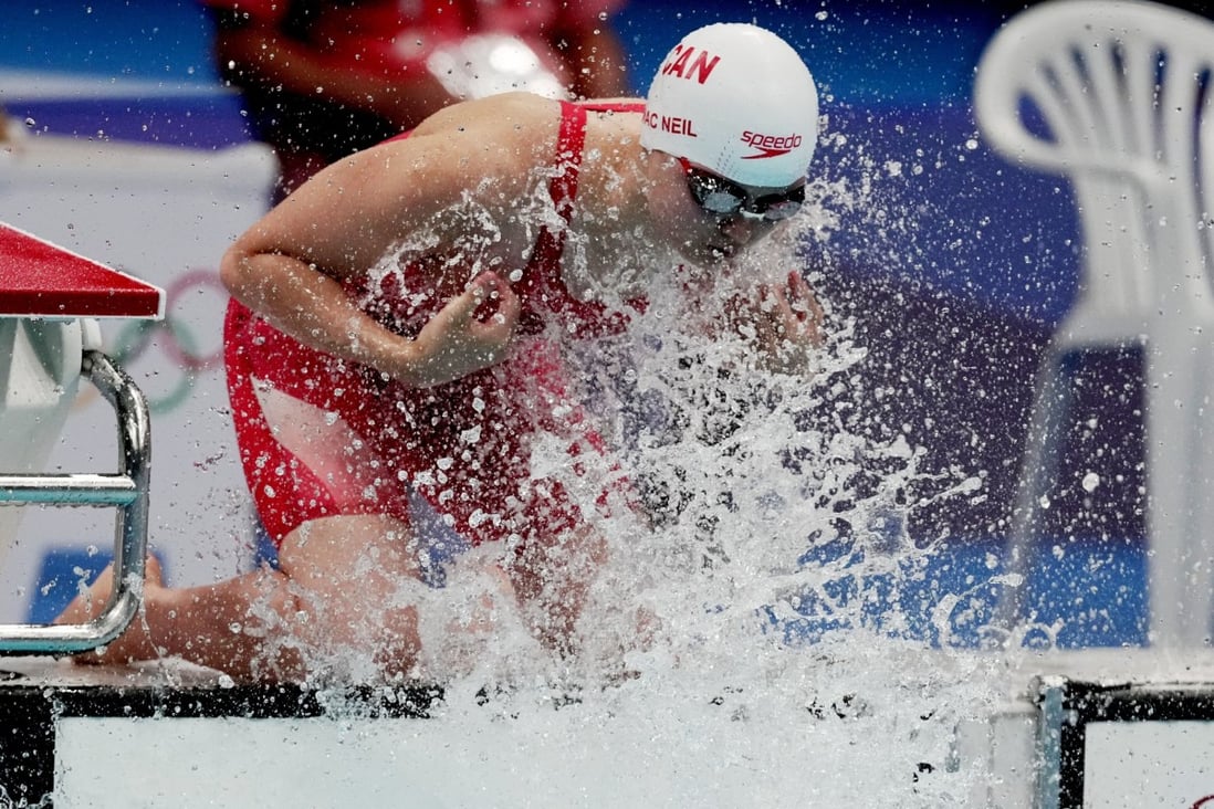 Canada’s Maggie MacNeil likes to splash herself with pool water before racing. Photo: Reuters