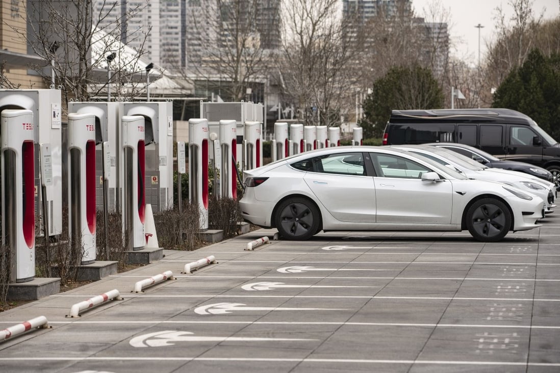 Tesla electric vehicles at charging stations outside one of the company's showrooms in Beijing on Saturday, March 6, 2021. Photo: Bloomberg